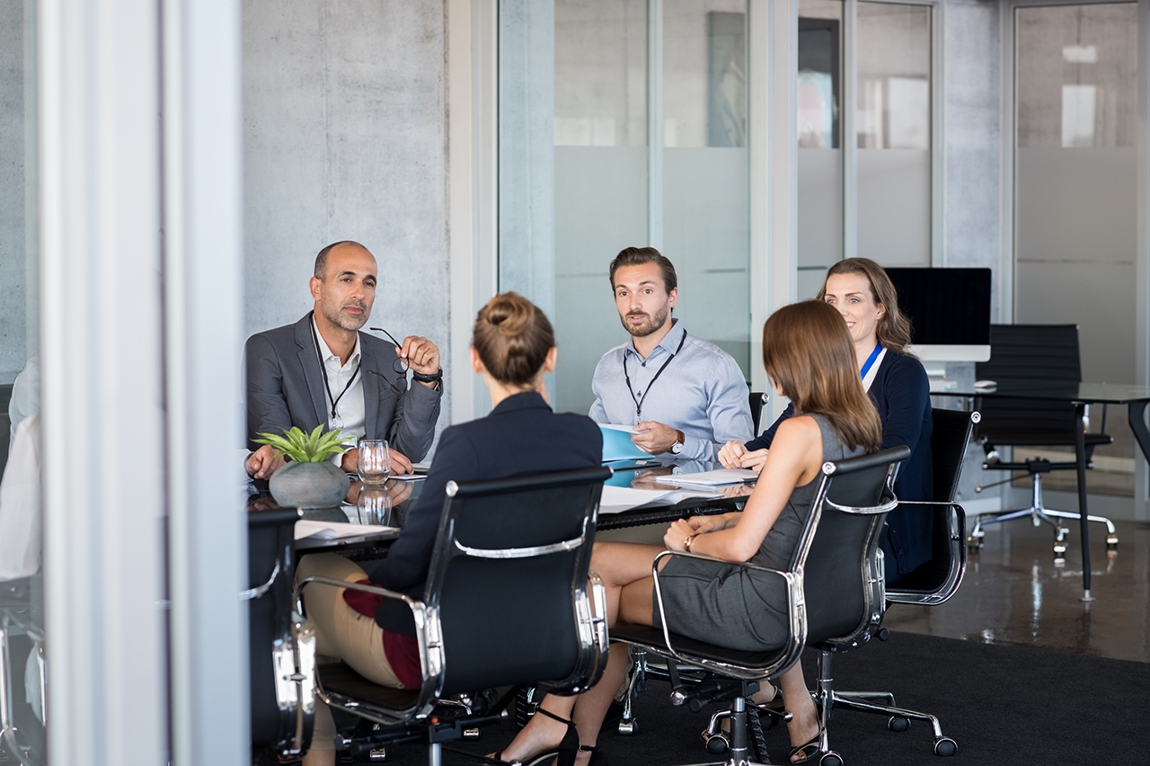 Business people sitting in boardroom and working together at new strategy plan. Group of leader and businesspeople in a meeting at office. Senior executive with his team working in a conference room.