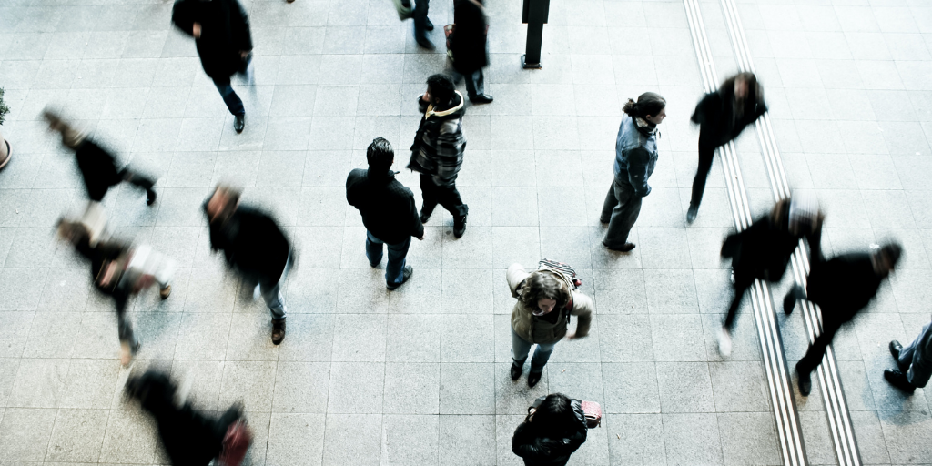 People walking in an office building foyer